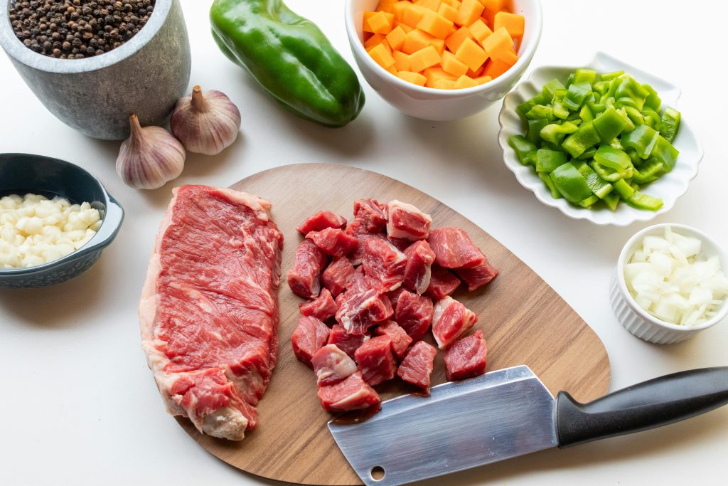 pexels photo 34705701 34705701 A variety of fresh ingredients including beef, vegetables, and seasonings ready for a homemade stew.