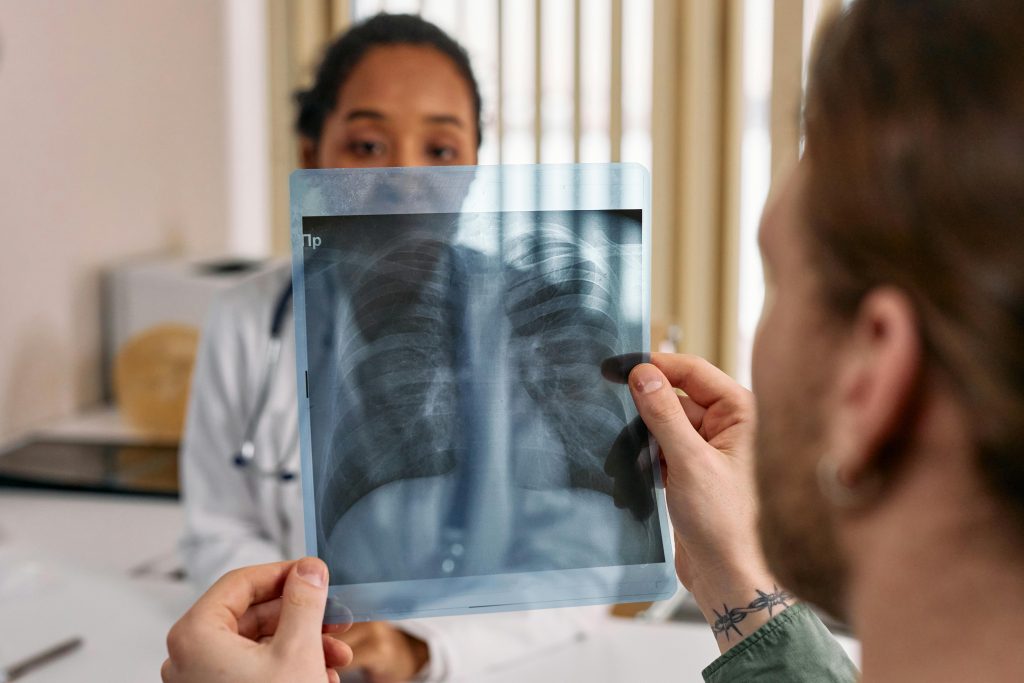 pexels photo 7579820 7579820 Doctor reviews chest x-ray results with patient in a medical office.