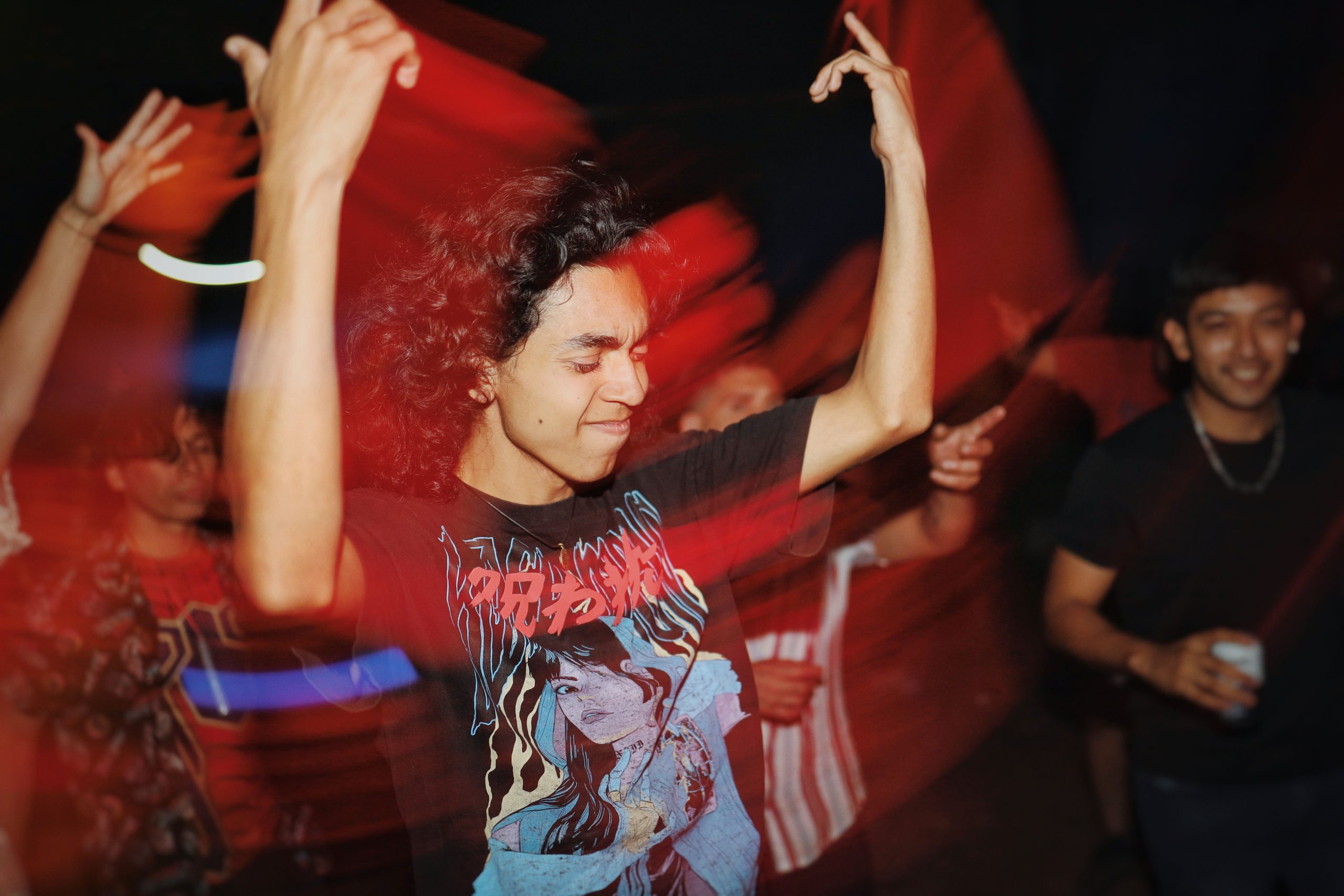 Lively group of friends dancing energetically at a night party in Tamaulipas, México.
