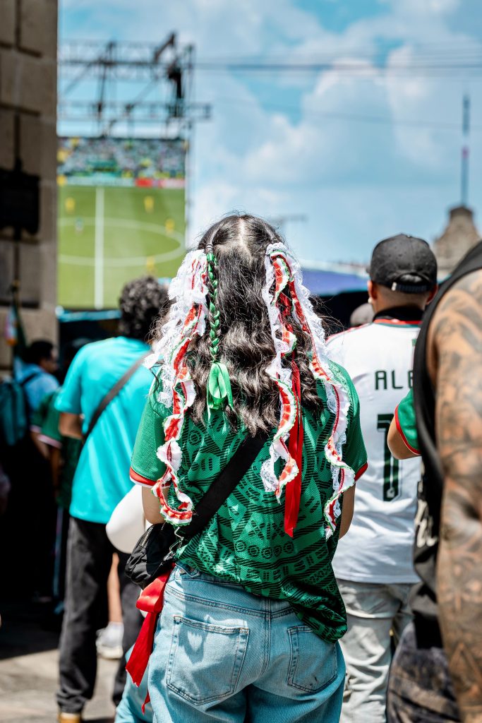 Crowd enjoying live soccer match in vibrant atmosphere at Ciudad de México.