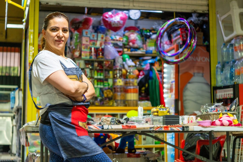 pexels photo 16837824 16837824 Latin American woman proudly standing at her vibrant Ciudad de México market stall.