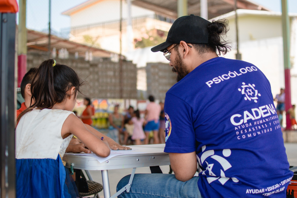 Brigadistas y voluntarios de protección civil organizando suministros de auxilio humanitario